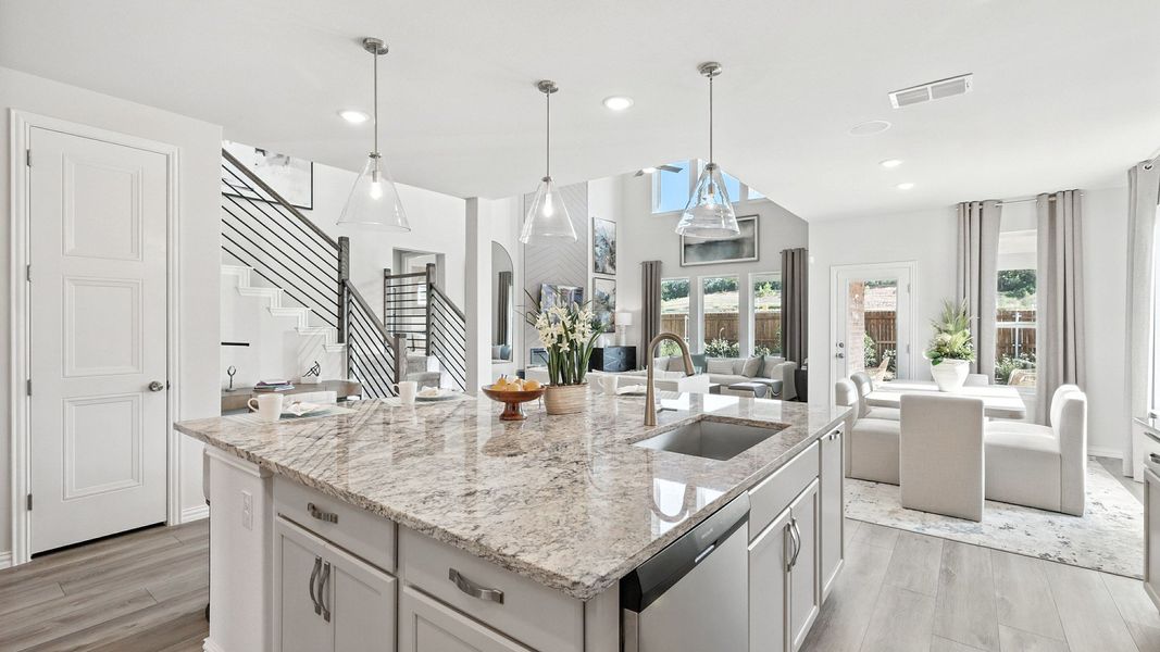 Granite countertops, sleek lighting, and airy space define this Green Oaks Preserve home's sophisticated kitchen. Granite countertops, sleek lighting, and airy space define this Green Oaks Preserve home's sophisticated kitchen.