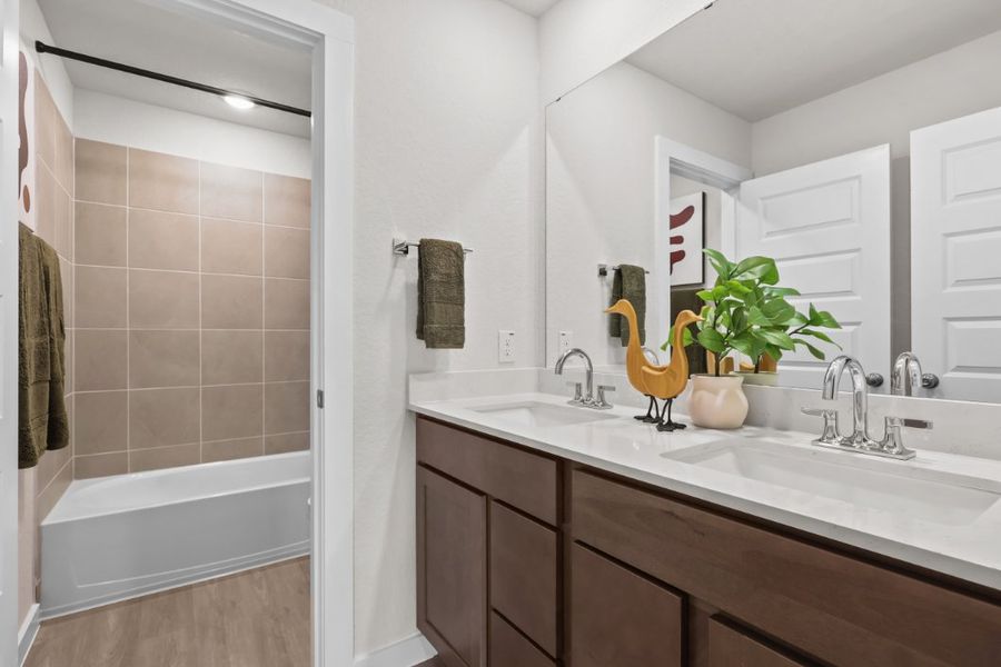 A bathroom with a sink and a bathtub. A bathroom with a sink and a bathtub.
