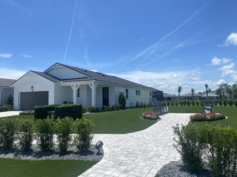 A charming white home with a landscaped yard and patio in RiverTown - WaterSong by Mattamy Homes (St. Johns, FL). A charming white home with a landscaped yard and patio in RiverTown - WaterSong by Mattamy Homes (St. Johns, FL).