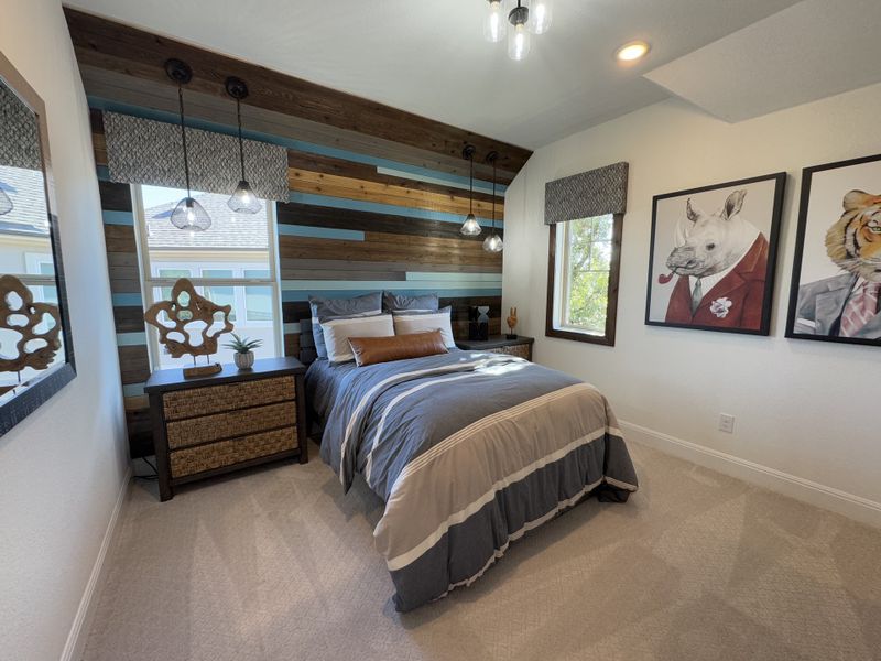 A cozy bedroom featuring a striped wood accent wall, modern pendant lights, and playful animal artwork. A cozy bedroom featuring a striped wood accent wall, modern pendant lights, and playful animal artwork.