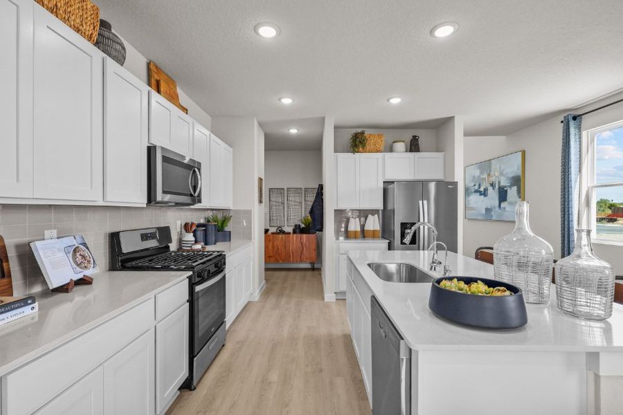 A kitchen with white cabinets.