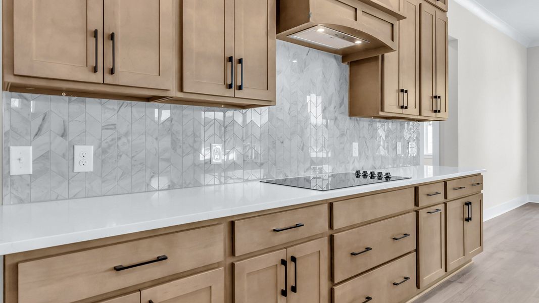 Gorgeous kitchen finishes with tile backsplash, upgraded cabinets, and quartz countertops Gorgeous kitchen finishes with tile backsplash, upgraded cabinets, and quartz countertops