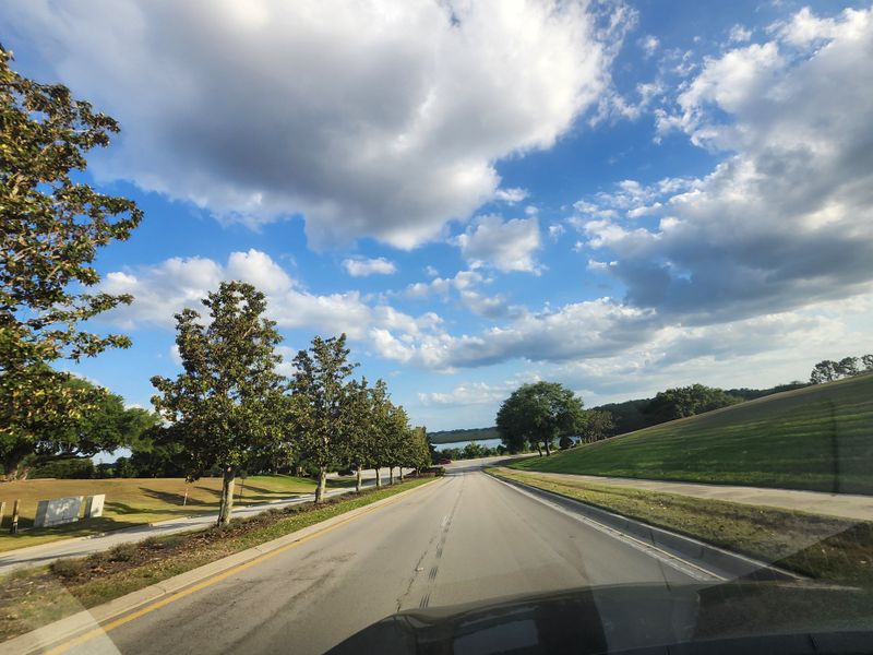 Scenic drive through lush landscapes in Hidden Ridge: Estate Collection by Lennar (Groveland, FL).