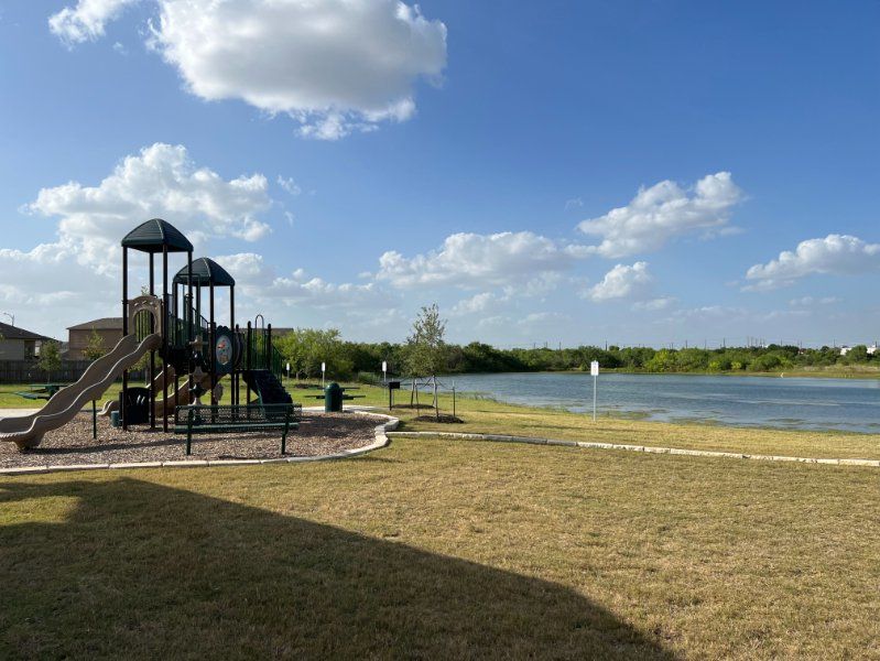 A large metal structure next to a body of water.