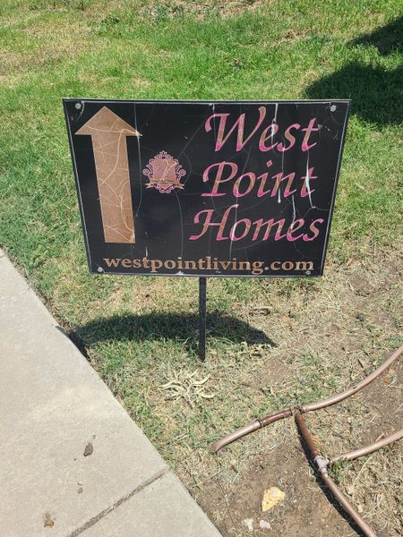 A West Point Homes sign on a grassy spot in Riverdance community by West Point Homes in Keller, TX.