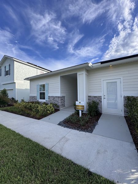 Charming modern home with elegant siding and manicured landscaping in Amberly by Dream Finders Homes (Green Cove Springs, FL). Charming modern home with elegant siding and manicured landscaping in Amberly by Dream Finders Homes (Green Cove Springs, FL).