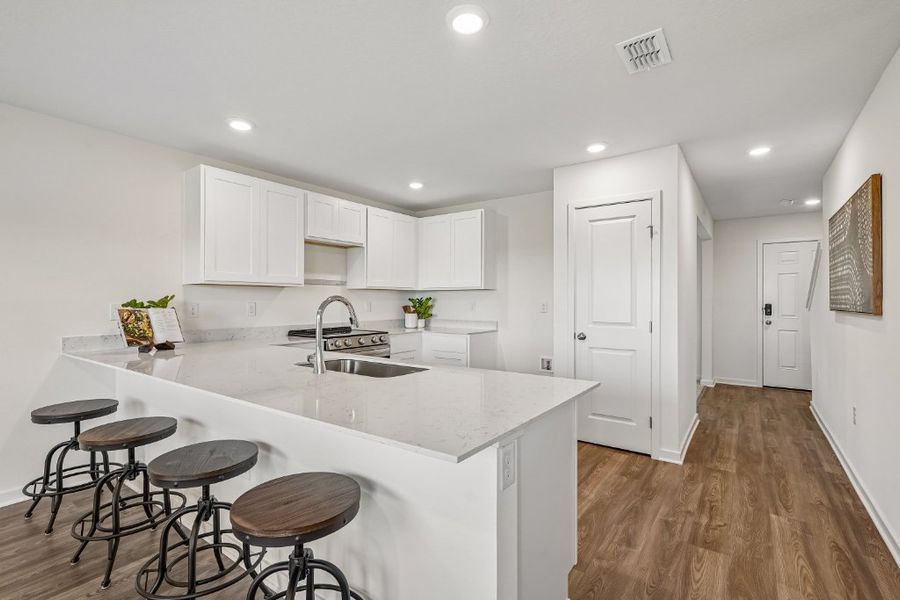 A kitchen with stools and a table. A kitchen with stools and a table.