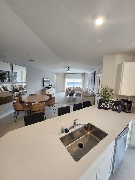 An open-concept kitchen with a sleek island, modern fittings, and a cozy adjacent dining area.