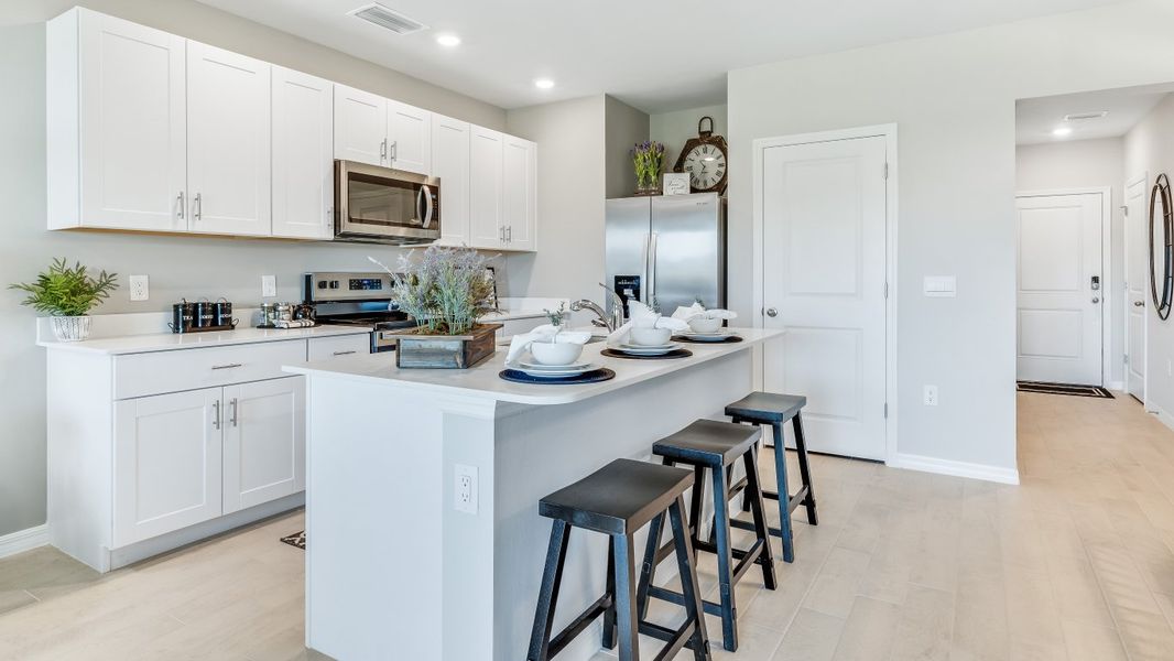 Furnished interior in a model home at Asher Park in Lehigh Acres (Image 5).