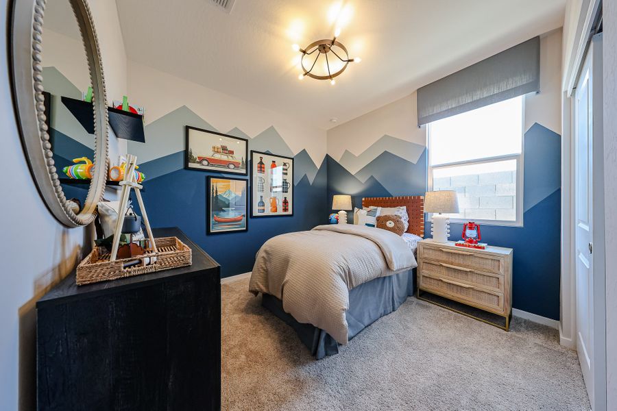 A bedroom with a bed and dresser.