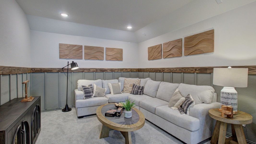 Sophisticated living room with plush sectional, intricate wainscoting, located in Meyer Ranch, Enclave community.