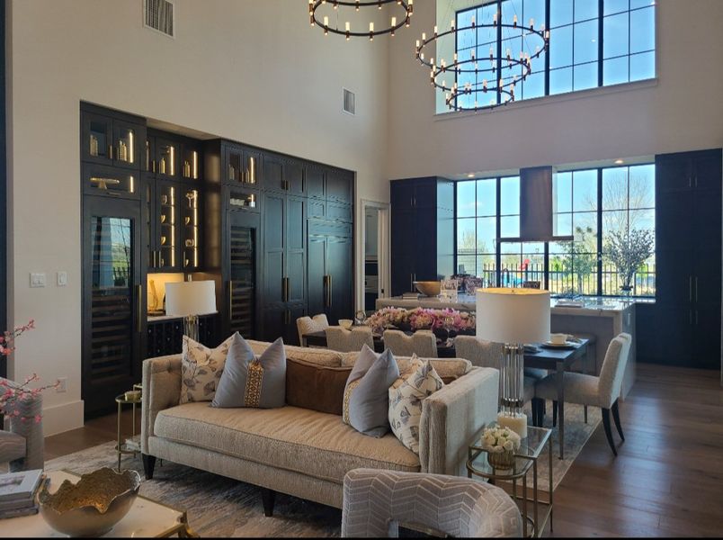 A luxurious living room with plush sofas, elegant lighting, and expansive windows for natural light.