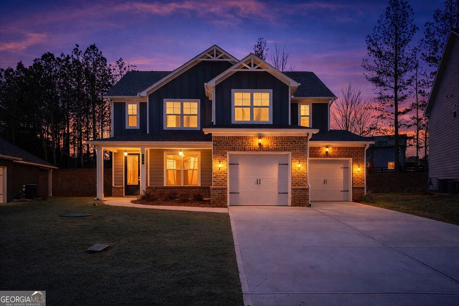 Front exterior of a new home in The Fairways at Mirror Lake, Villa Rica, GA, highlighting curb appeal (Image 2). Front exterior of a new home in The Fairways at Mirror Lake, Villa Rica, GA, highlighting curb appeal (Image 2).