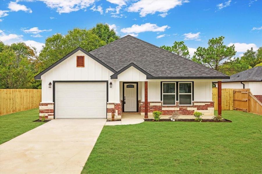 View of front facade with a porch, a shingled roof, brick siding, and concrete driveway View of front facade with a porch, a shingled roof, brick siding, and concrete driveway