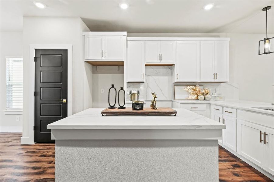 Kitchen featuring white cabinets, tasteful backsplash, a kitchen island, and recessed lighting Kitchen featuring white cabinets, tasteful backsplash, a kitchen island, and recessed lighting