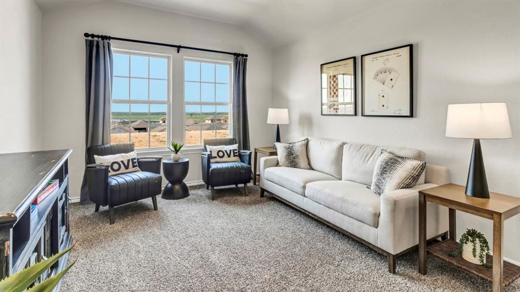 Spacious room featuring vaulted ceilings, two large windows with grid patterns, light-toned carpeting, and neutral wall finishes Spacious room featuring vaulted ceilings, two large windows with grid patterns, light-toned carpeting, and neutral wall finishes