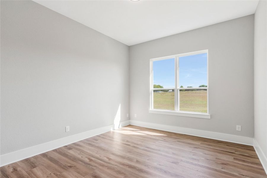 Bright and airy bedroom with serene views and sleek flooring—perfect for relaxation. Bright and airy bedroom with serene views and sleek flooring—perfect for relaxation.