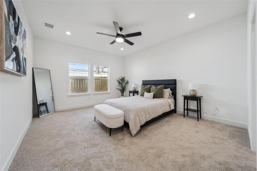 Carpeted Primary bedroom (1st floor) featuring ceiling fan