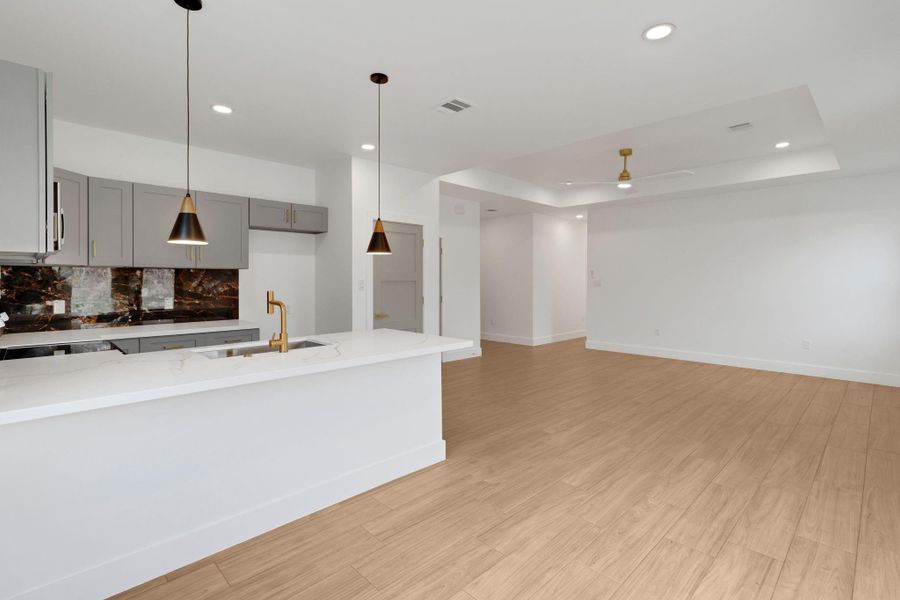 Living room features open living, ceiling fans, and plenty of light