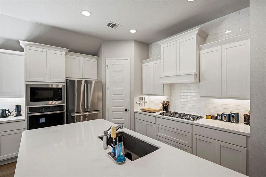 The gourmet kitchen features a large island