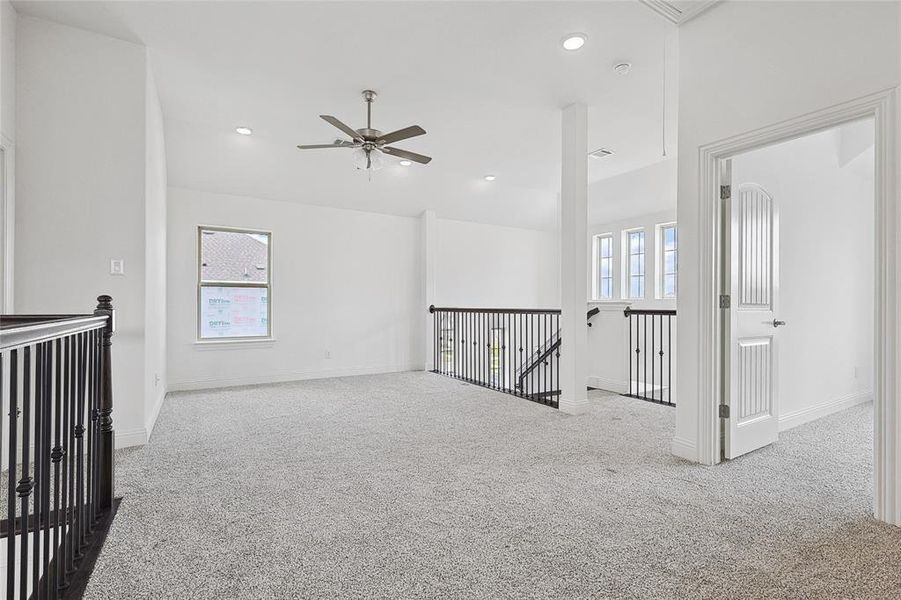 Spare room featuring ceiling fan and light colored carpet