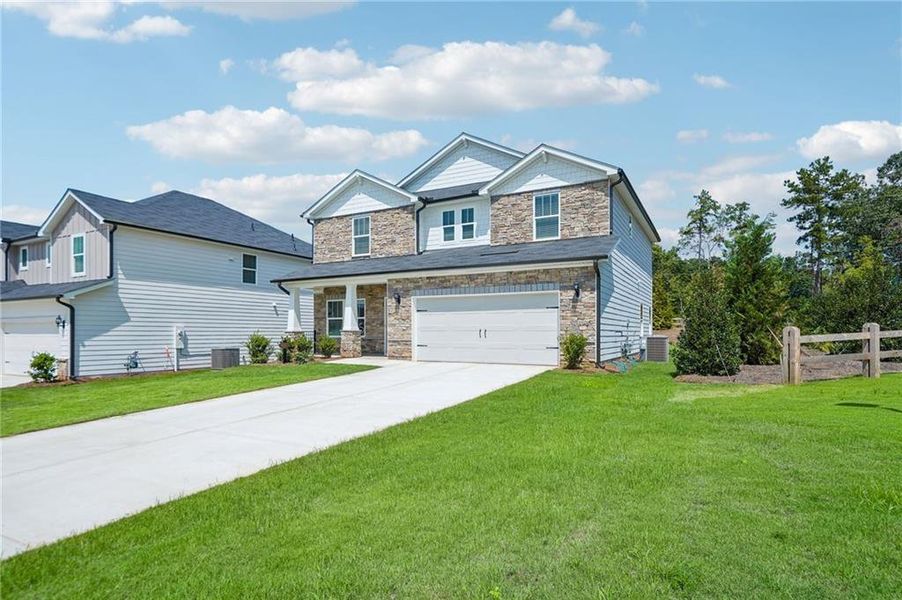 Front exterior of a new home in Vines at Mill Creek - Estate Series, Braselton, GA, highlighting curb appeal (Image 22). Front exterior of a new home in Vines at Mill Creek - Estate Series, Braselton, GA, highlighting curb appeal (Image 22).