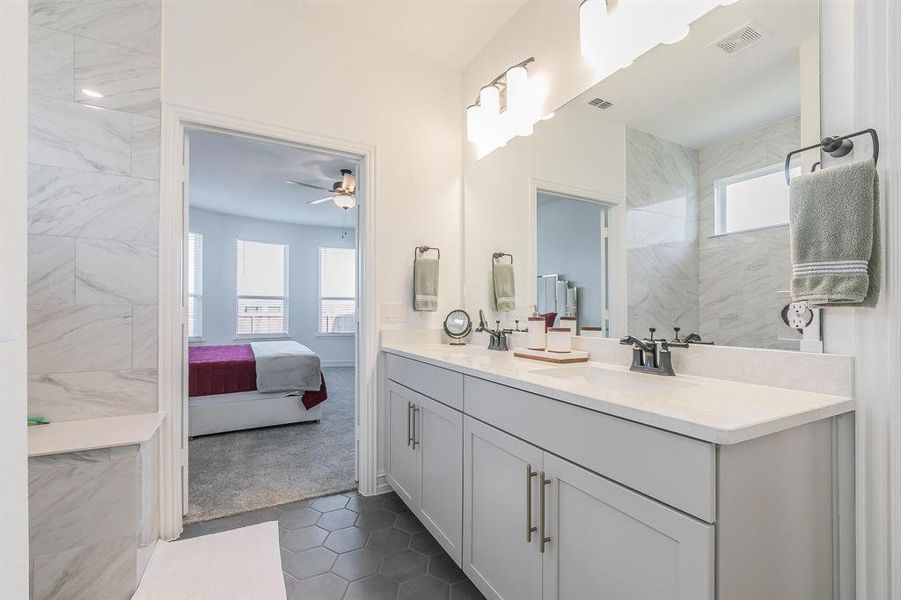 Bathroom featuring tile patterned flooring, vanity, and ceiling fan