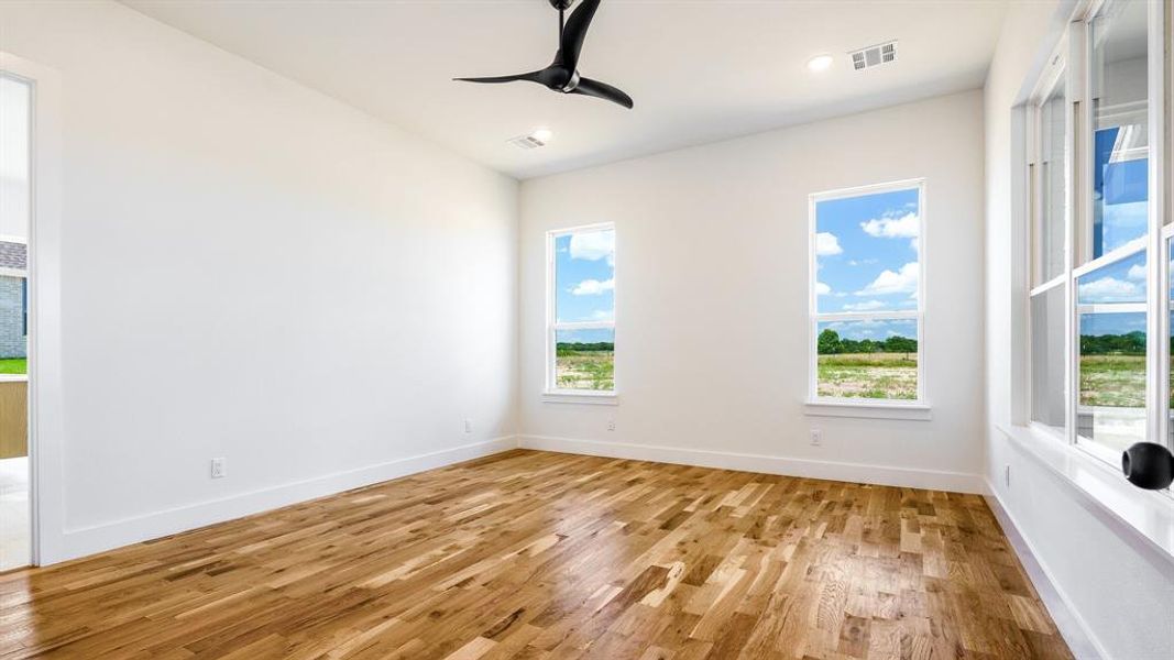 Unfurnished room featuring light hardwood / wood-style floors and ceiling fan