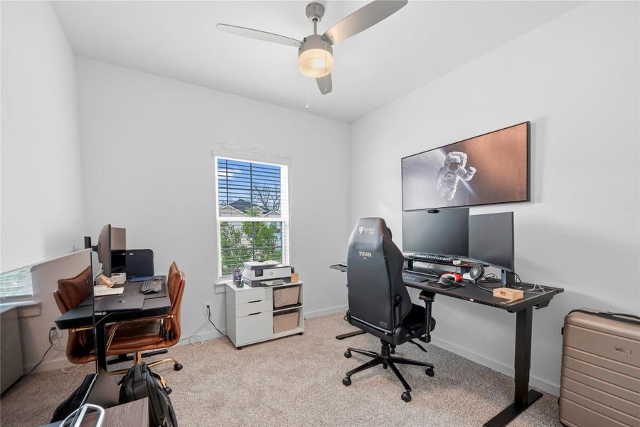 A bedroom converted into a dedicated workspace offers ample room for a large desk and media setup, providing a functional and versatile environment. A bedroom converted into a dedicated workspace offers ample room for a large desk and media setup, providing a functional and versatile environment.