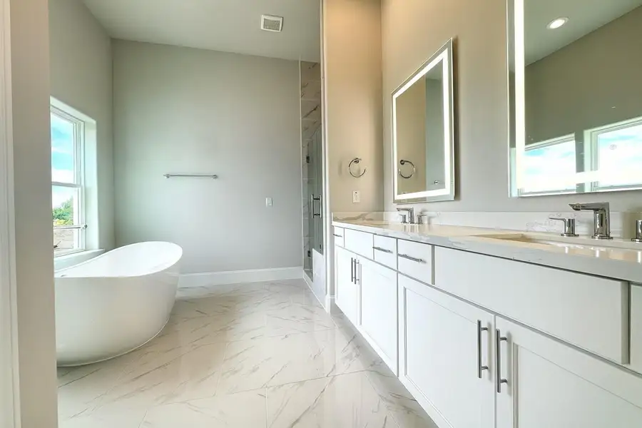 Bathe in natural light in this luxurious primary bathroom.