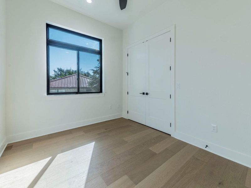 Unfurnished bedroom featuring wood finished floors, a closet, and a ceiling fan Unfurnished bedroom featuring wood finished floors, a closet, and a ceiling fan
