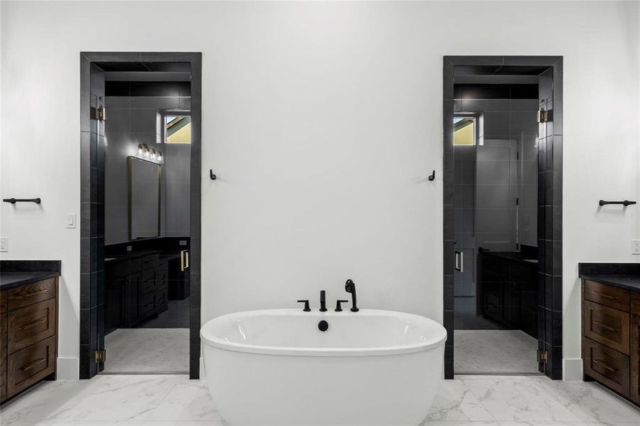 Full bath with vanity, light marble finish floors, a shower stall, and a soaking tub Full bath with vanity, light marble finish floors, a shower stall, and a soaking tub