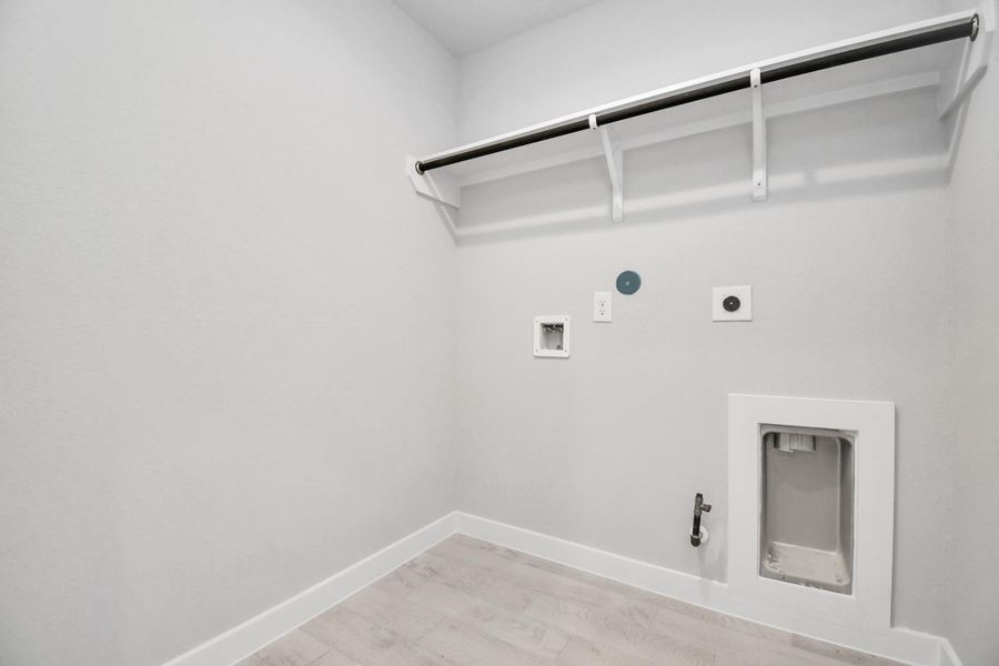 A perfect blend of functionality and comfort. Capture the essence of easy living with a first-floor laundry room, thoughtfully equipped with shelving for effortless organization. Both electric and gas connections available. A perfect blend of functionality and comfort. Capture the essence of easy living with a first-floor laundry room, thoughtfully equipped with shelving for effortless organization. Both electric and gas connections available.