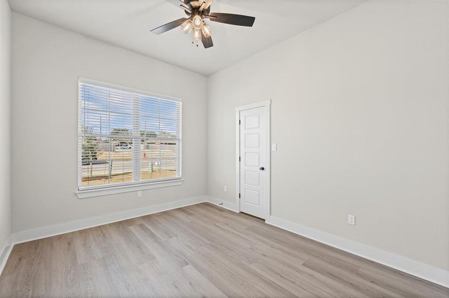 Unfurnished room with light wood-style flooring and ceiling fan