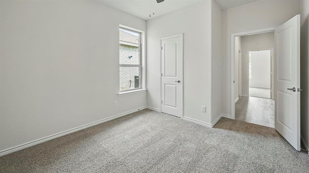 Unfurnished bedroom featuring light carpet