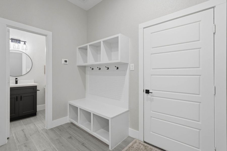 Mudroom off the garage and half bath. Mudroom off the garage and half bath.