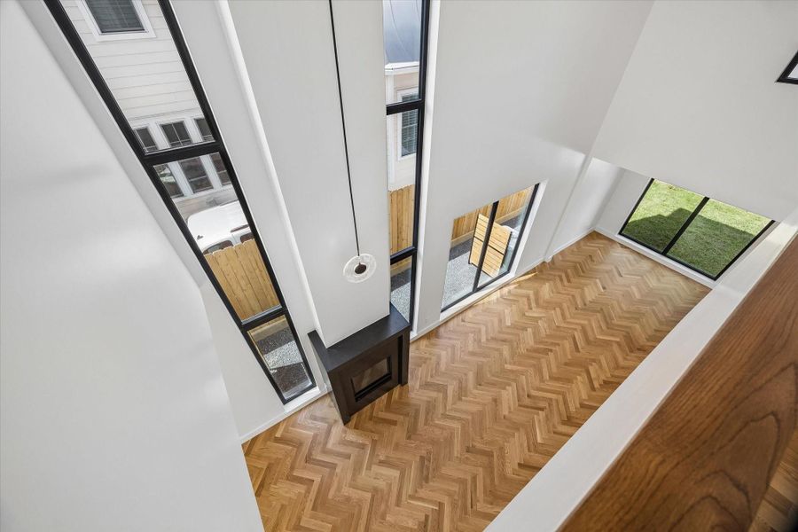 Stunning open-concept space with soaring ceilings, elegant herringbone wood floors, and abundant natural light from floor-to-ceiling windows. Stunning open-concept space with soaring ceilings, elegant herringbone wood floors, and abundant natural light from floor-to-ceiling windows.