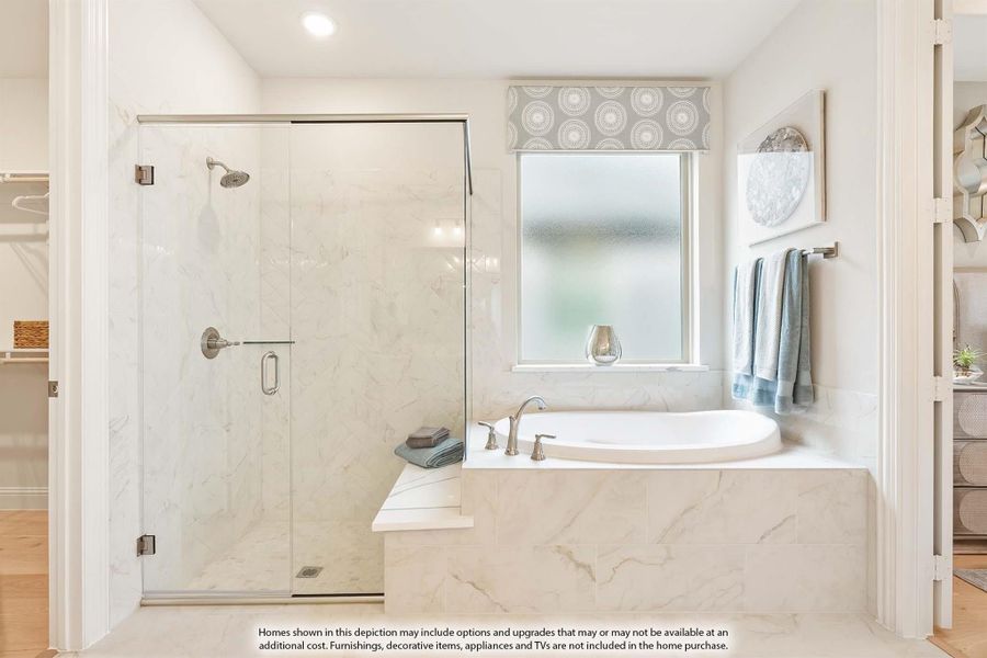 Master bathroom with marble soaking tub, glass-enclosed shower, and frosted privacy window