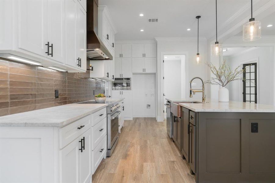 Cooper brown subway back splash wall tile, pot filler and featuring stainless steel appliances