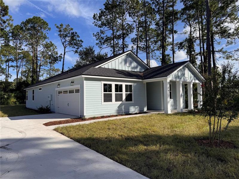 Front exterior of a new home in Palm Coast Homes, Palm Coast, FL, highlighting curb appeal (Image 20).