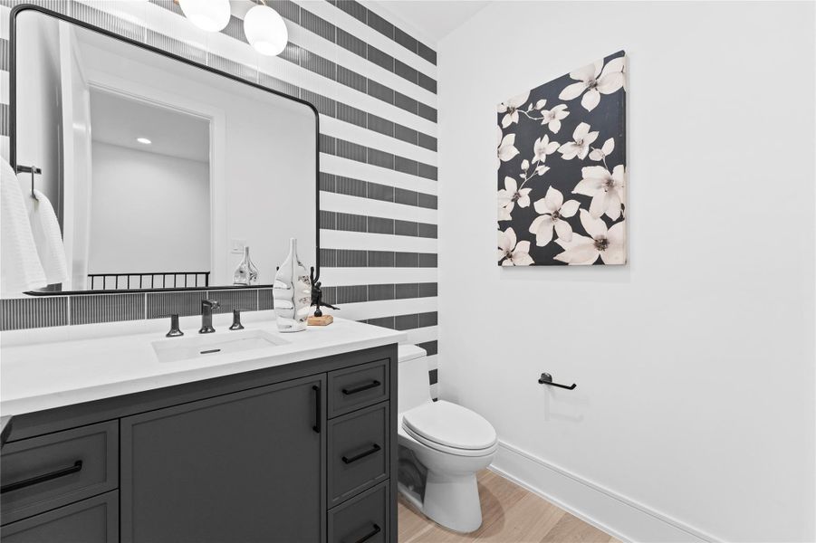 Designer tile and modern finishes on third floor powder bath.