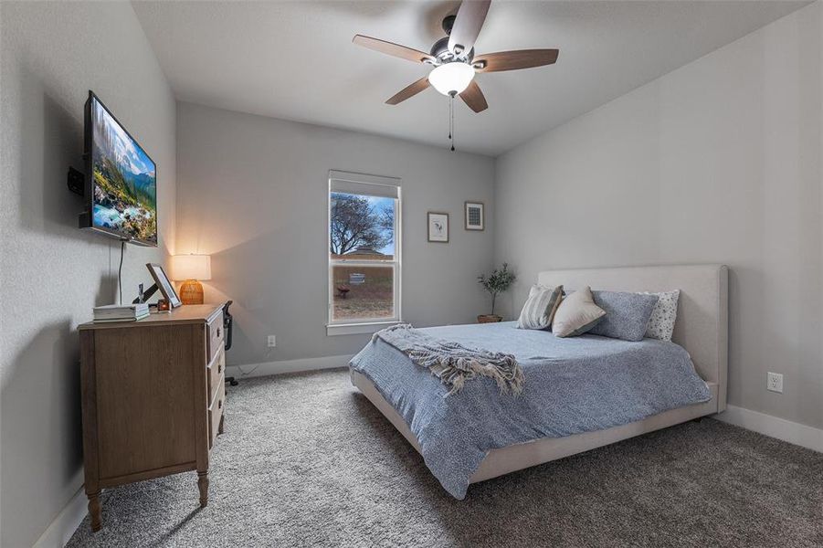 Bedroom with ceiling fan and carpet