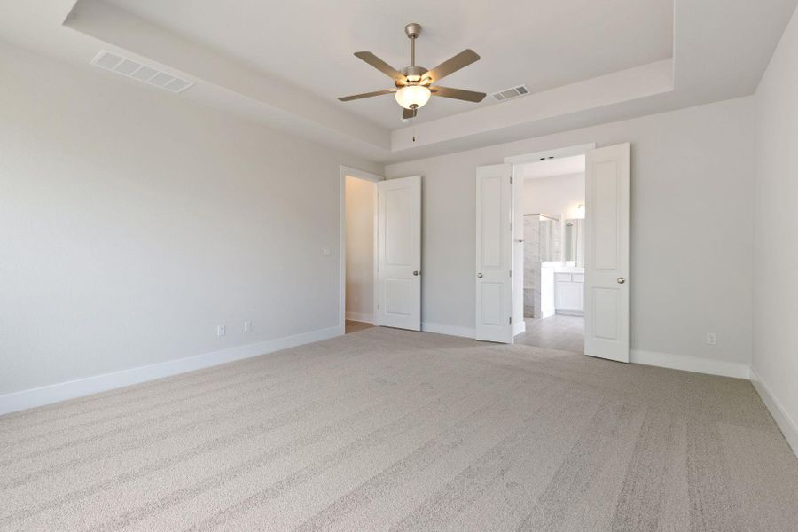 Primary Bedroom with elevated ceiling Primary Bedroom with elevated ceiling