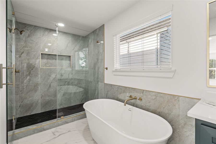 Melt the stress away. The deep, freestanding soaking tub sits perfectly beneath the window, creating your own private oasis for relaxation.