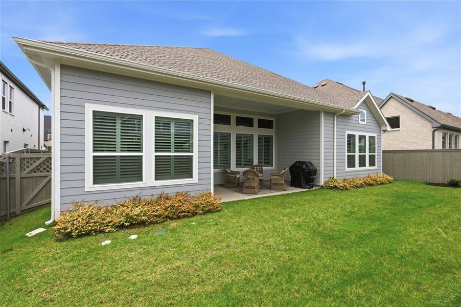 Exterior details and patio area of a home in Pecan Square – Classics, Northlake (Image 21).