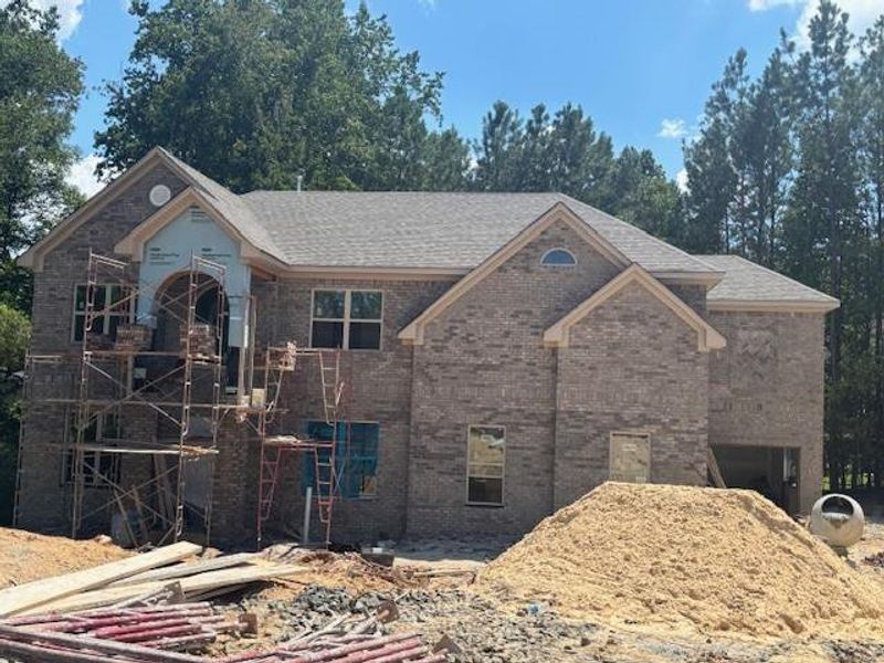 Front exterior of a new home in Le Jardin, Fairburn, GA, highlighting curb appeal (Image 2). Front exterior of a new home in Le Jardin, Fairburn, GA, highlighting curb appeal (Image 2).