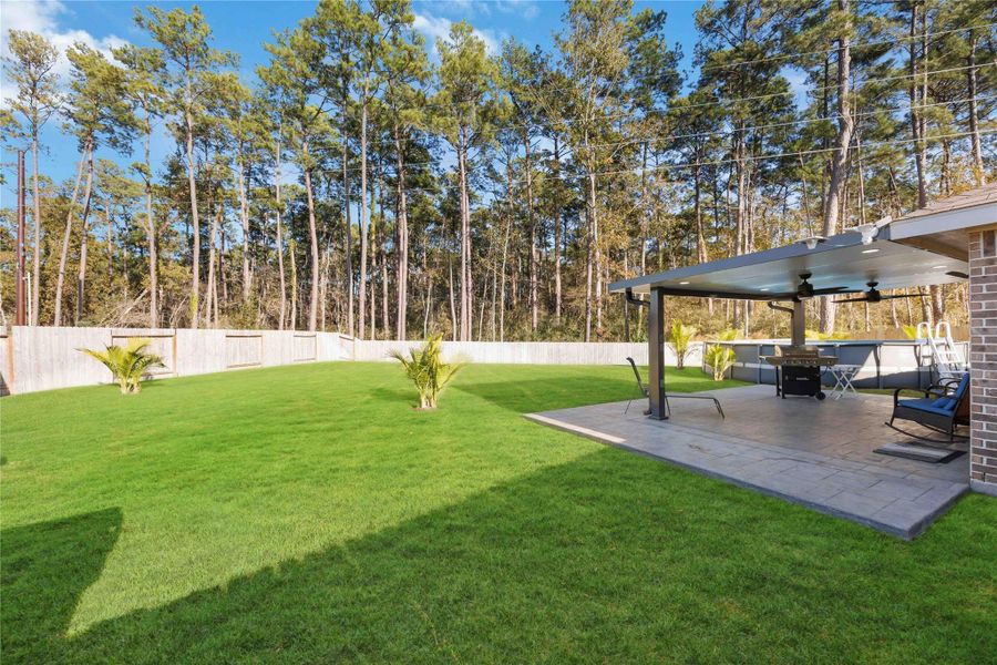 Backyard & Patio – Privacy ViewExpansive backyard framed by a tree-lined backdrop with no rear neighbors, offering exceptional privacy and a peaceful setting. The extended covered patio provides the perfect space for outdoor dining, lounging, or entertaining, while the generous lawn allows for endless possibilities including recreation, gardening, or future outdoor enhancements. A rare combination of space, privacy, and outdoor living. Backyard & Patio – Privacy ViewExpansive backyard framed by a tree-lined backdrop with no rear neighbors, offering exceptional privacy and a peaceful setting. The extended covered patio provides the perfect space for outdoor dining, lounging, or entertaining, while the generous lawn allows for endless possibilities including recreation, gardening, or future outdoor enhancements. A rare combination of space, privacy, and outdoor living.