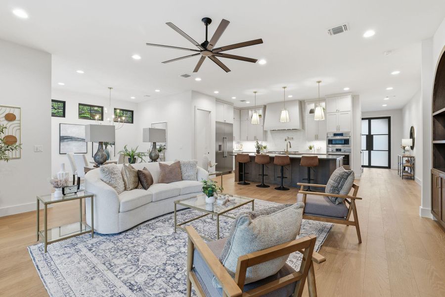 Living room featuring ceiling fan, light wood-type flooring, and recessed lighting