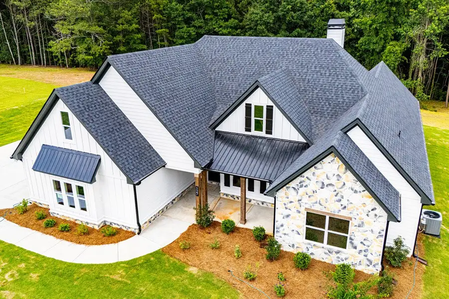 Front exterior of a new home in WOODMONT RESERVE, Roopville, GA, highlighting curb appeal (Image 43).
