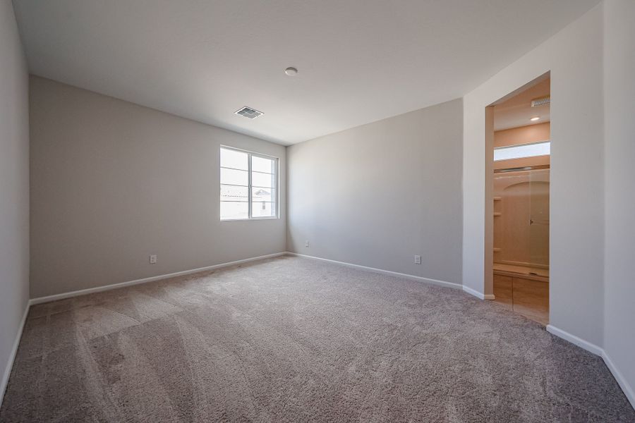 A room with a carpet and a door.